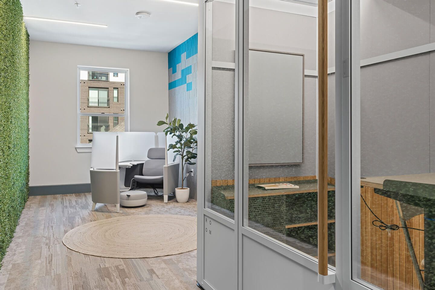 An artist 's impression of an office with a green wall and a glass door.