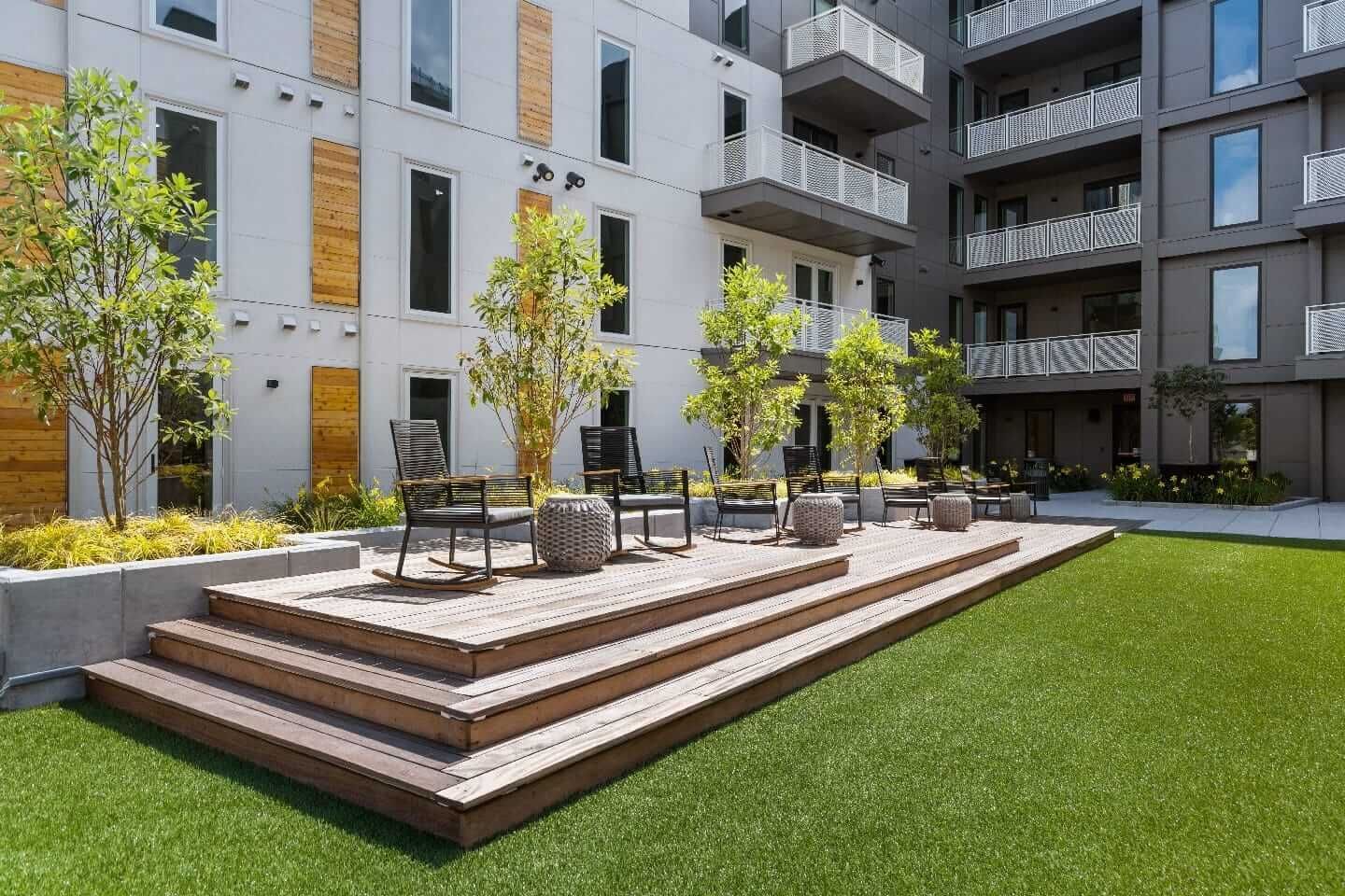 An artist 's impression of a patio area in front of a building.