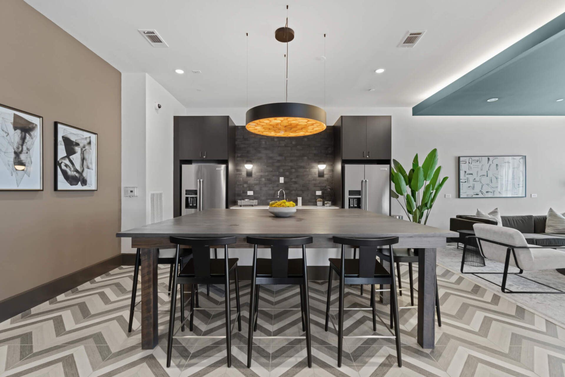 A kitchen with a large table and chairs in it.