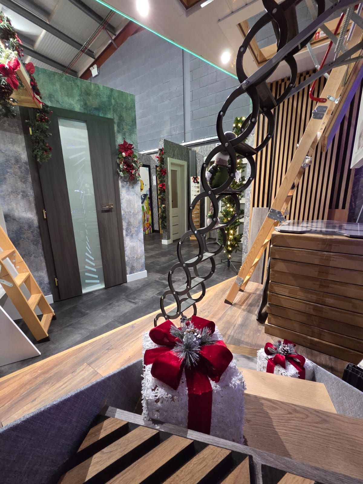Interior with Christmas decorations, doors, and a decorative chain sculpture on a gift box.