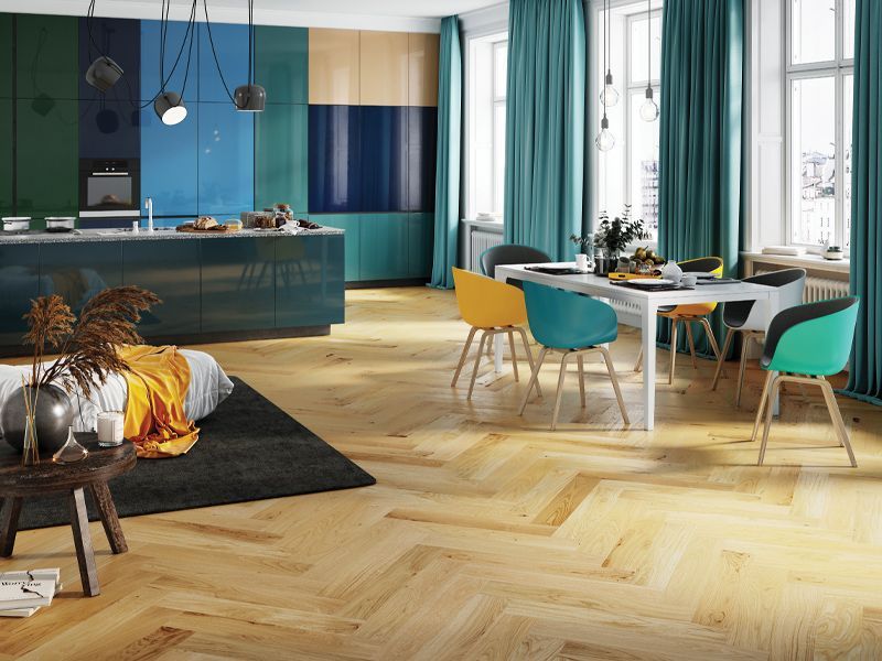 Stylish kitchen and dining area with colorful decor, wooden floors, and modern furniture.