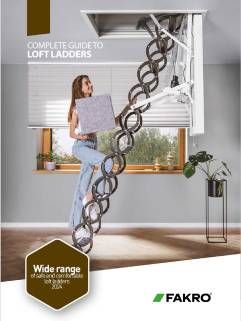 Woman using a folding loft ladder. She carries a box as she ascends. A window and plants are in the background.