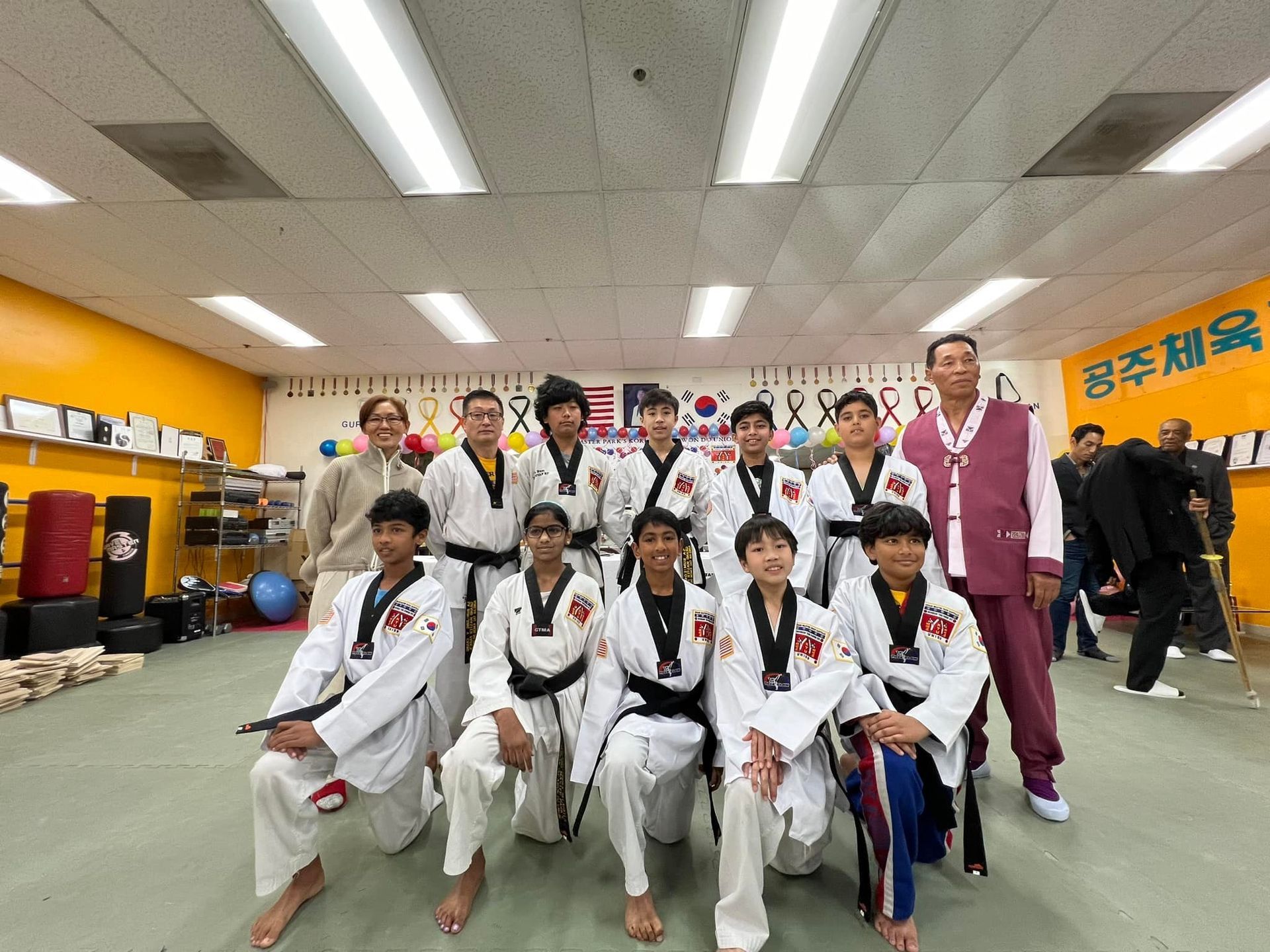 A group of people are posing for a picture in a gym.