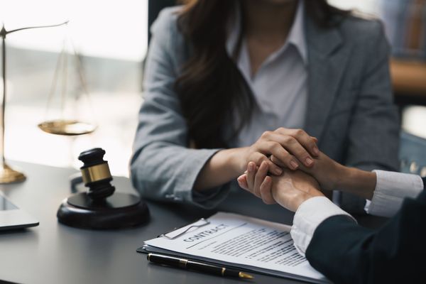 lawyers discussing divorce proceeding with woman