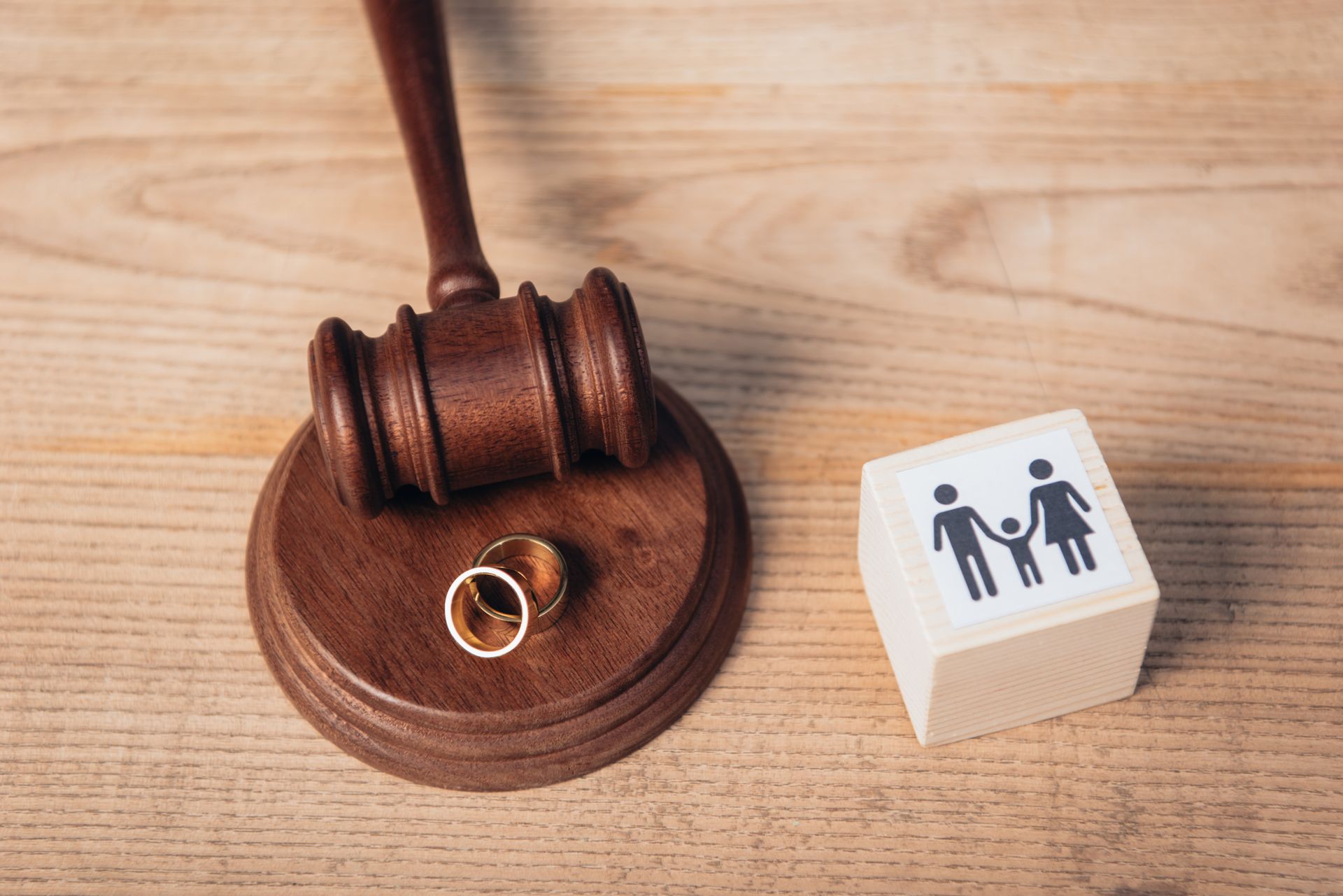 weddings rings next to gavel and picture of family being split up 
