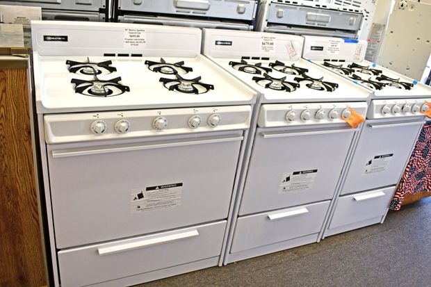 Three white gas stoves.