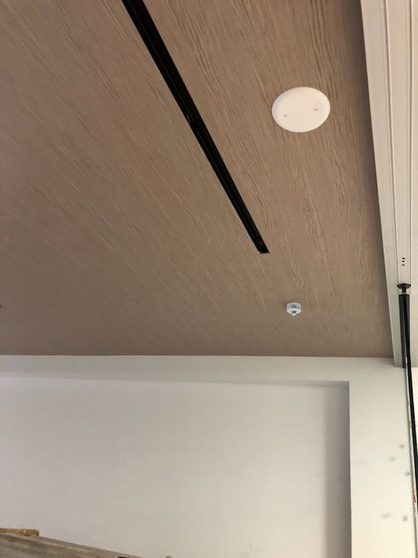 A room with a wooden ceiling and a white wall.