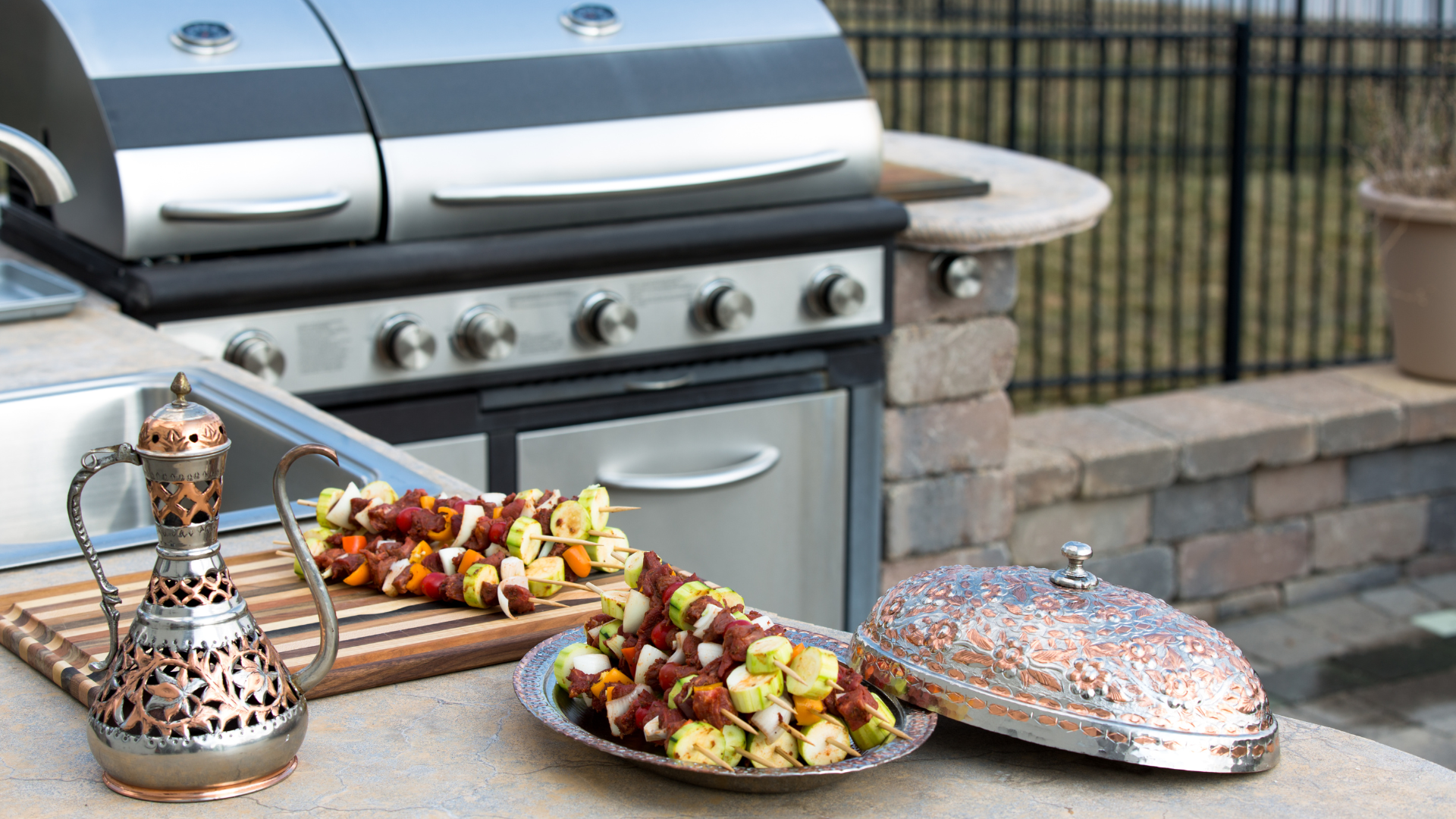 A grill is sitting on top of a counter next to a plate of food.