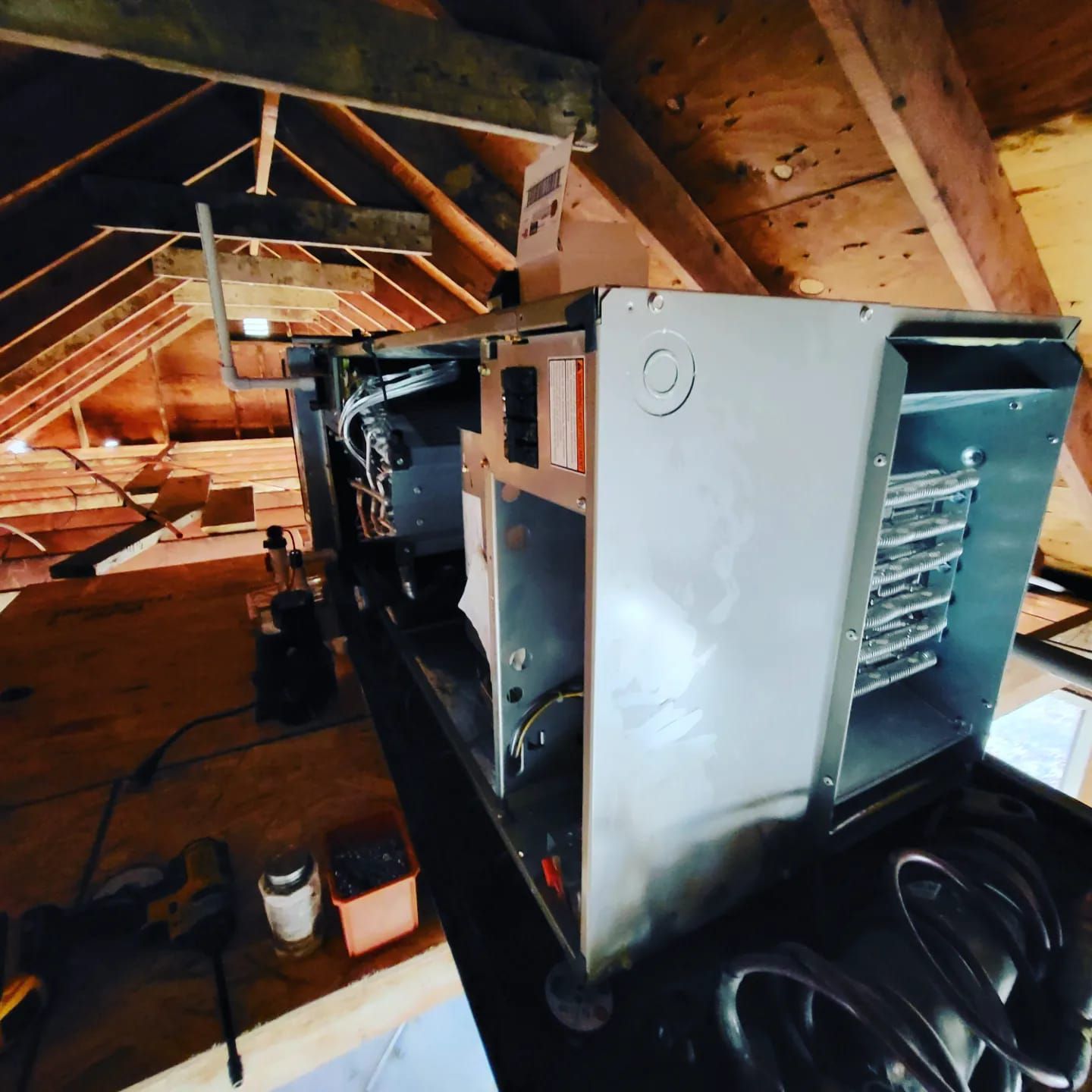A heater is sitting in the attic of a house