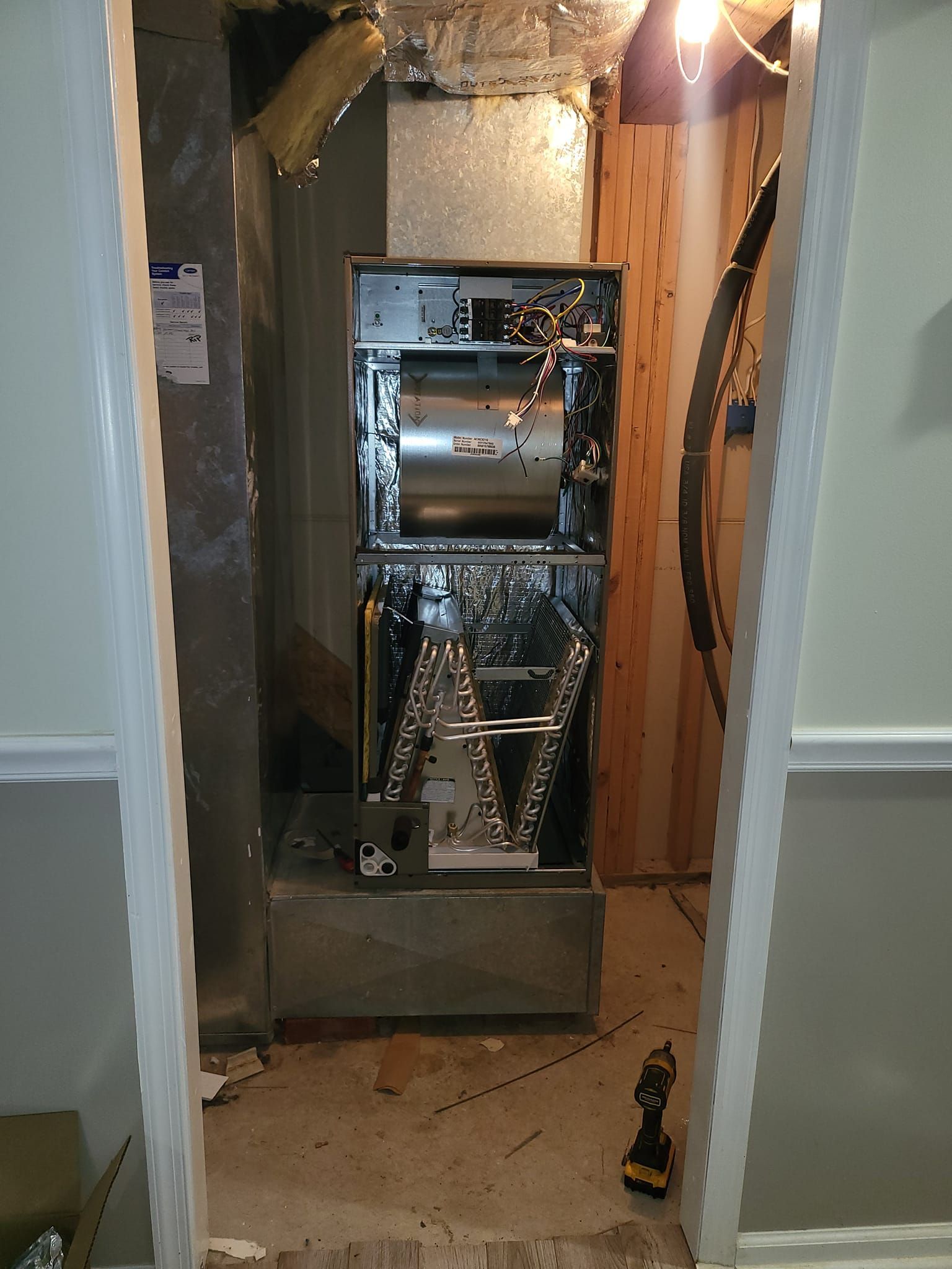 An air conditioner is being installed in a basement