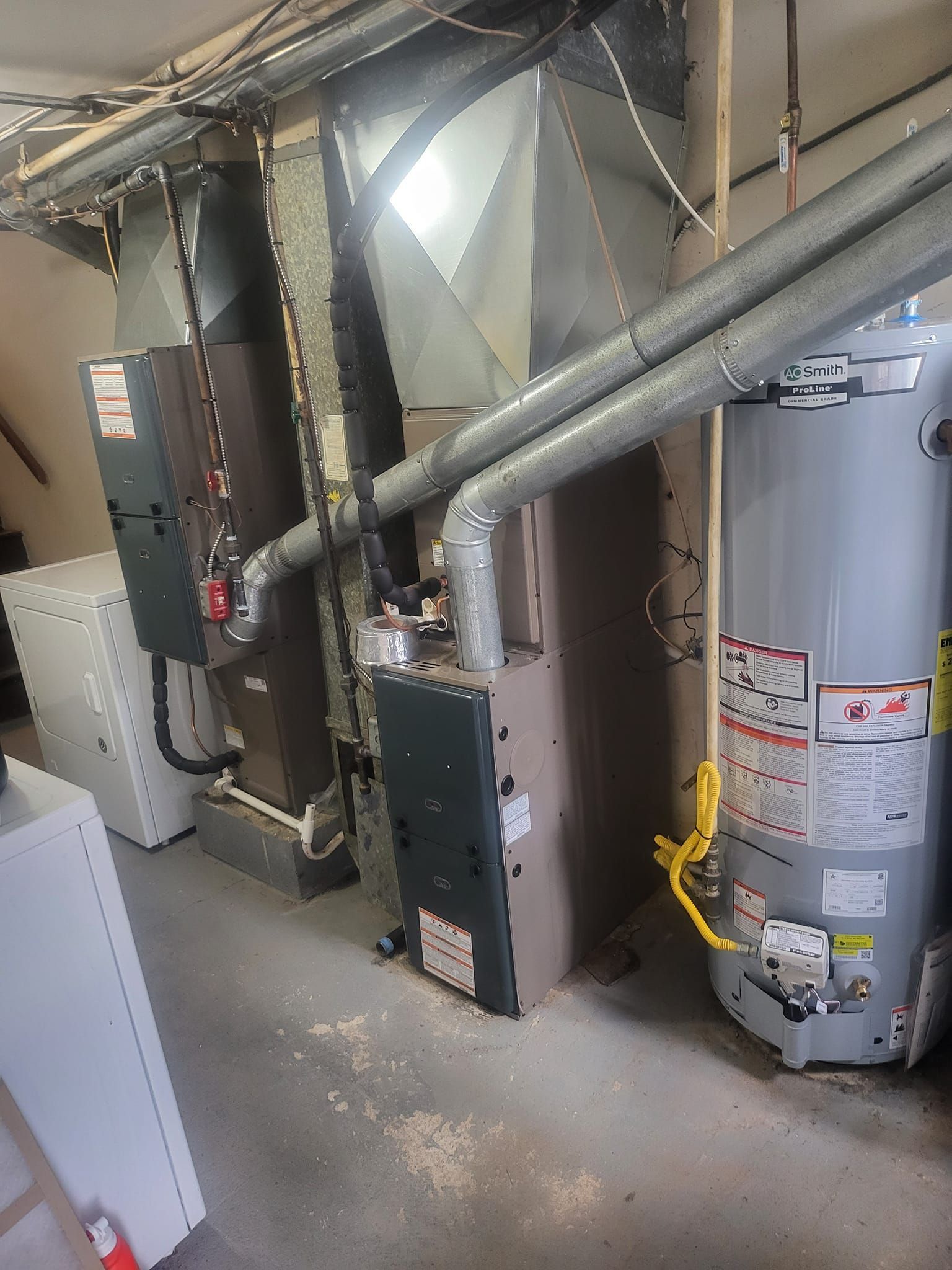 A room with a heater and a water heater in it.