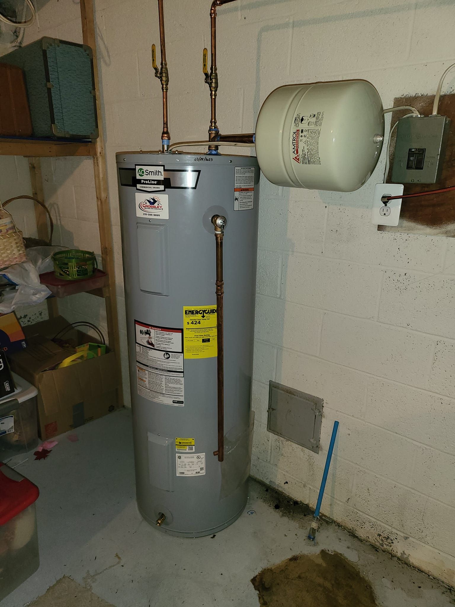 A water heater is sitting in a room next to a wall.