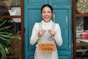 Woman in apron holds an 