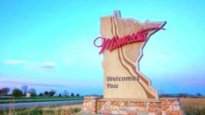 Minnesota welcome sign with state outline, script 