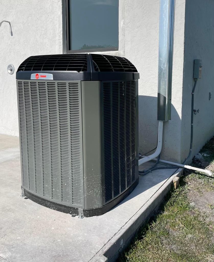 An air conditioner is sitting on the side of a building