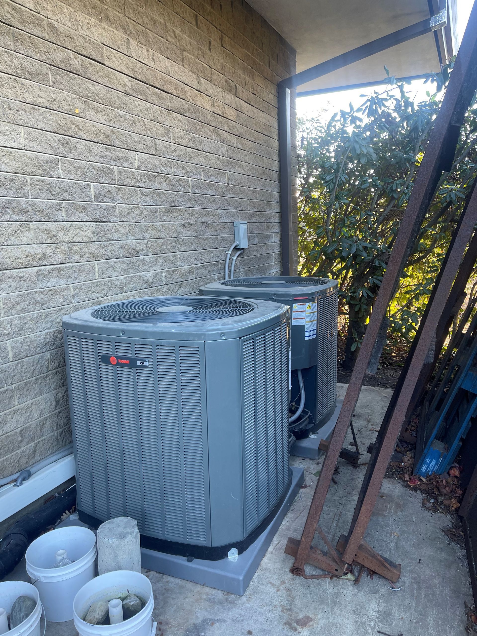 A row of air conditioners are sitting on the side of a building.