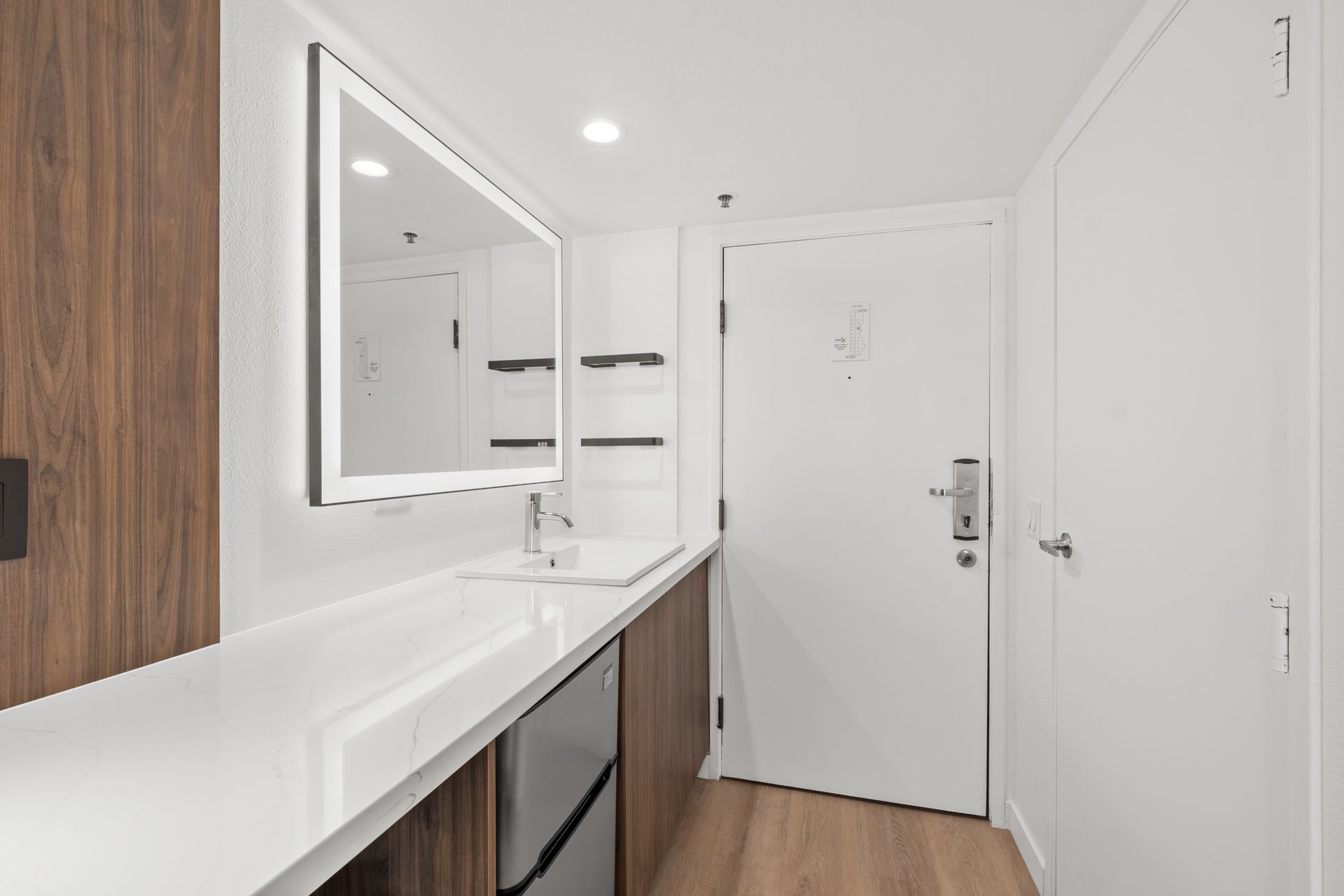 A bathroom with a sink , mirror and dishwasher.
