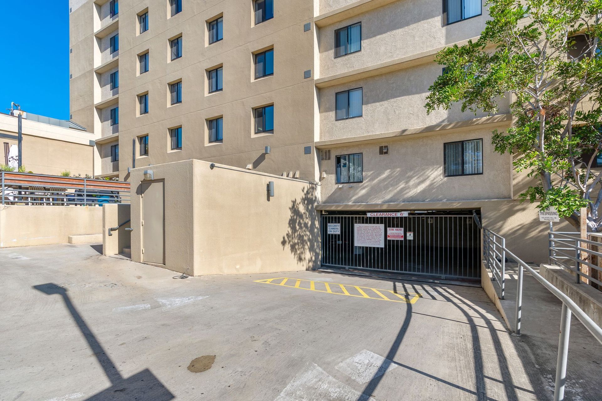 A large building with a parking garage in front of it