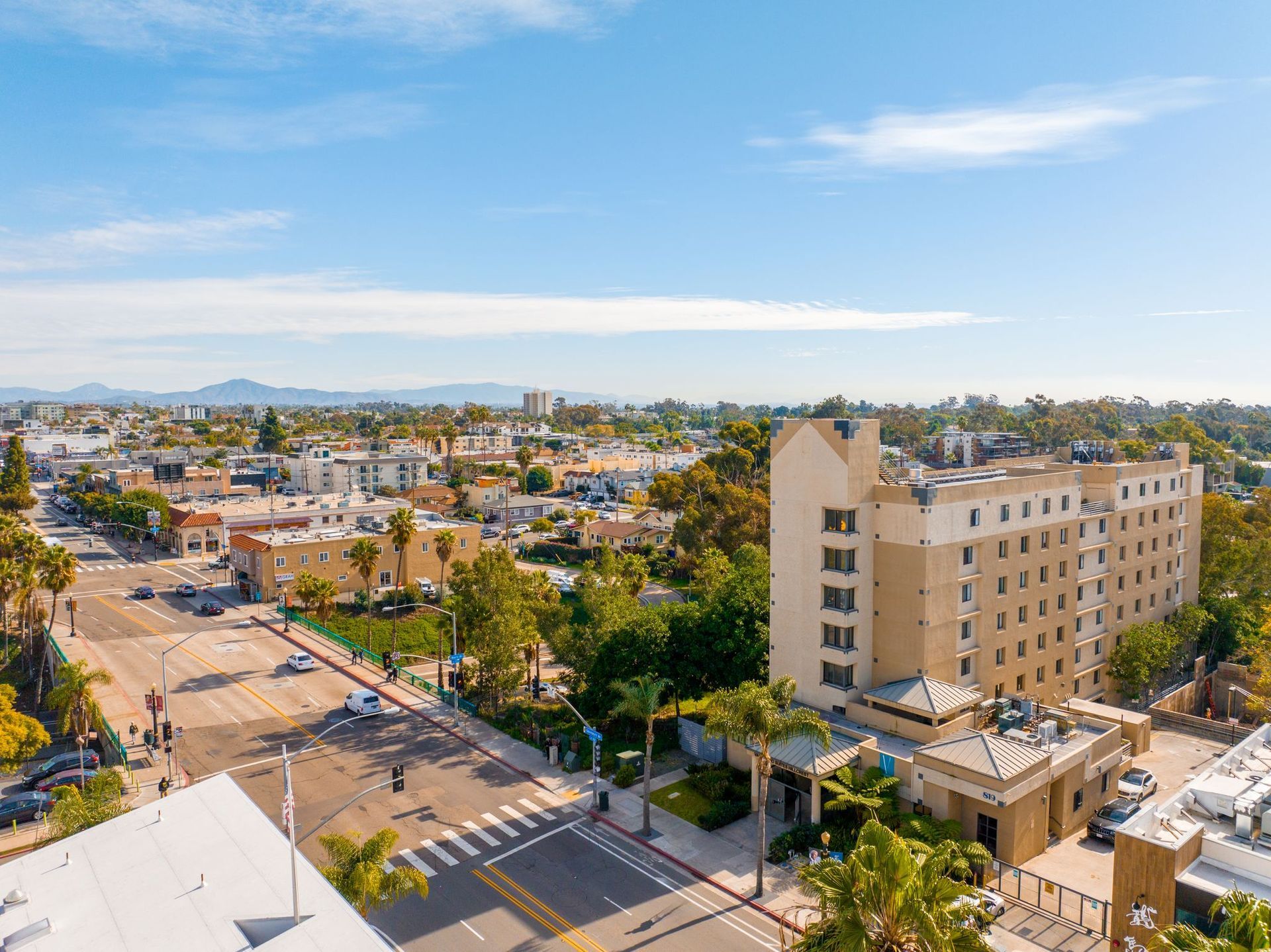 An aerial view of a city with a large building in the middle of it.