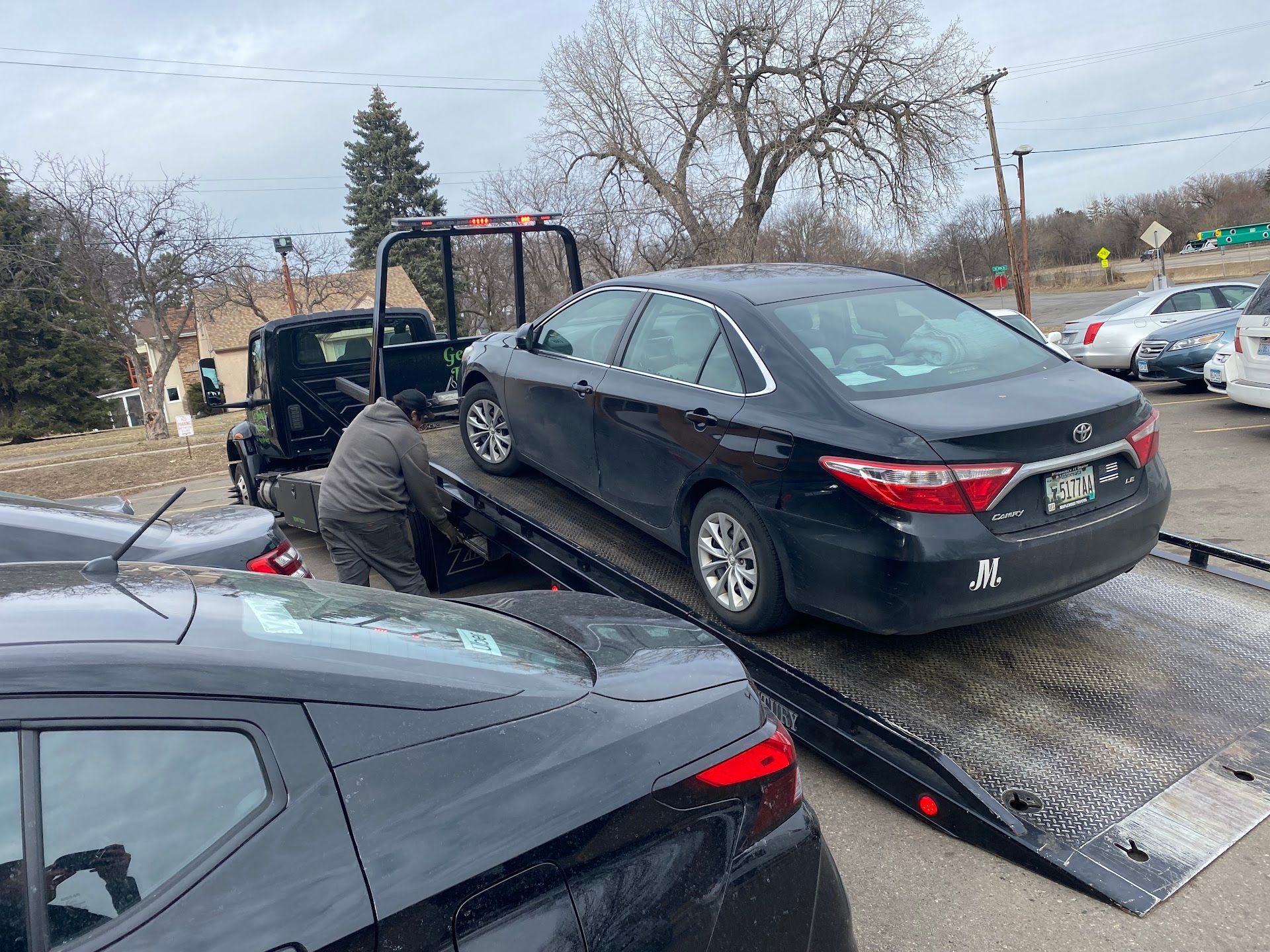 A Black Car Is Being Towed by a Tow Truck | Wilson's Auto World