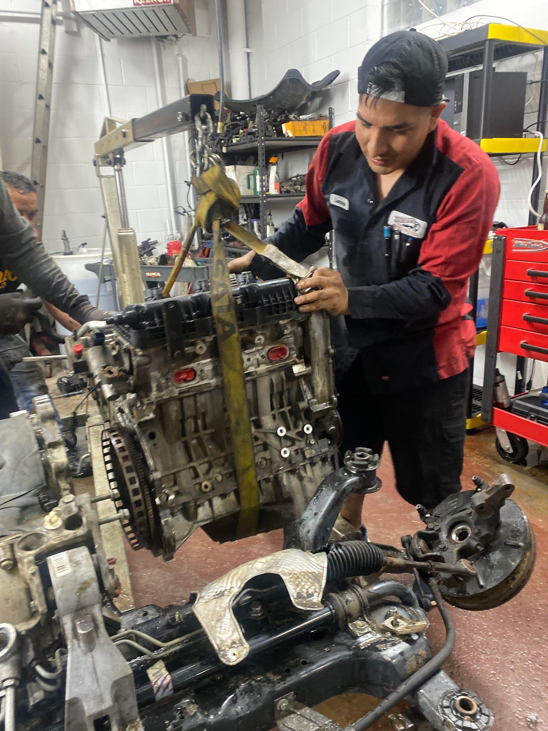 A Mechanic Is Working on a Car Engine in a Garage | Wilson's Auto World