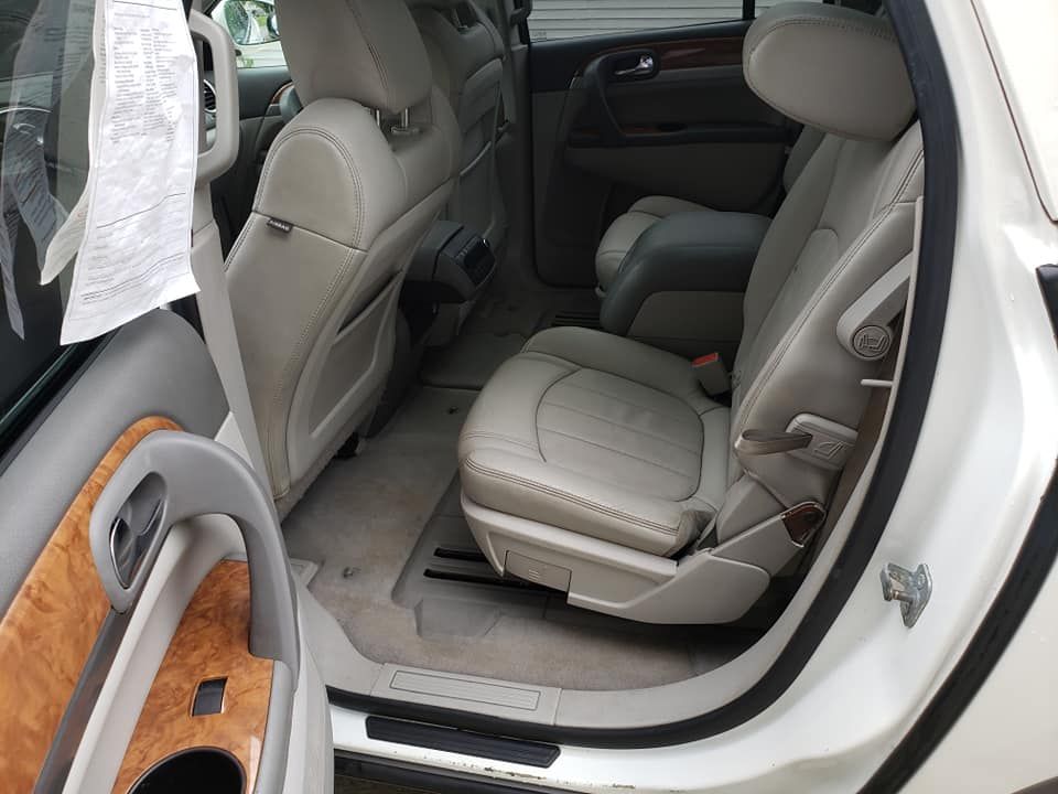 The back seat of a white car with the door open