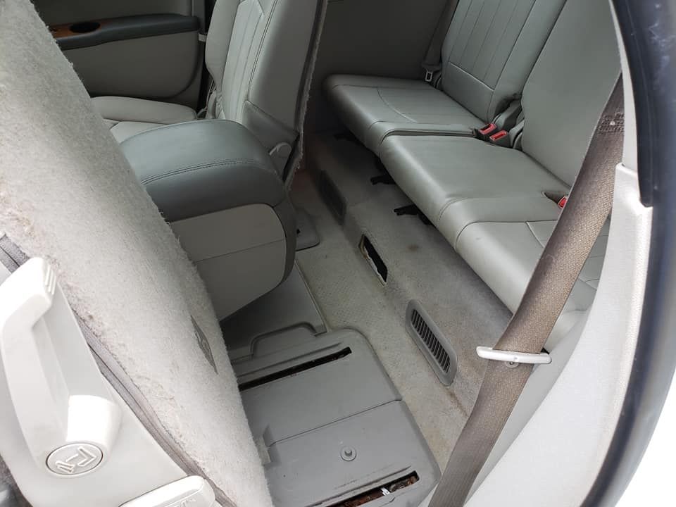 The back seat of a car has a seat belt on it