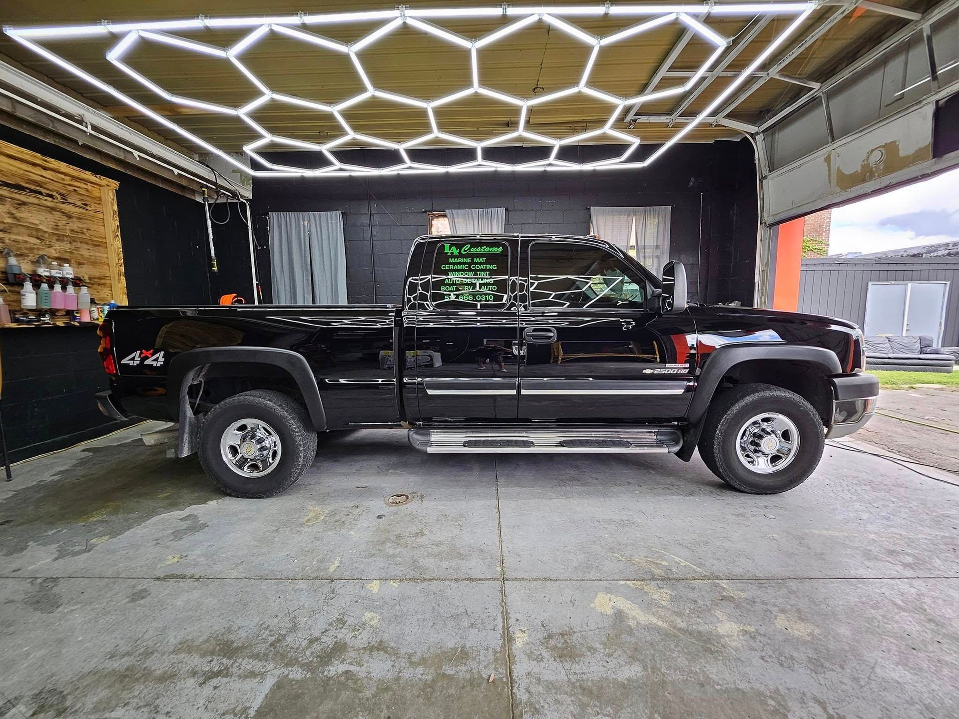 A black truck is parked in a garage.