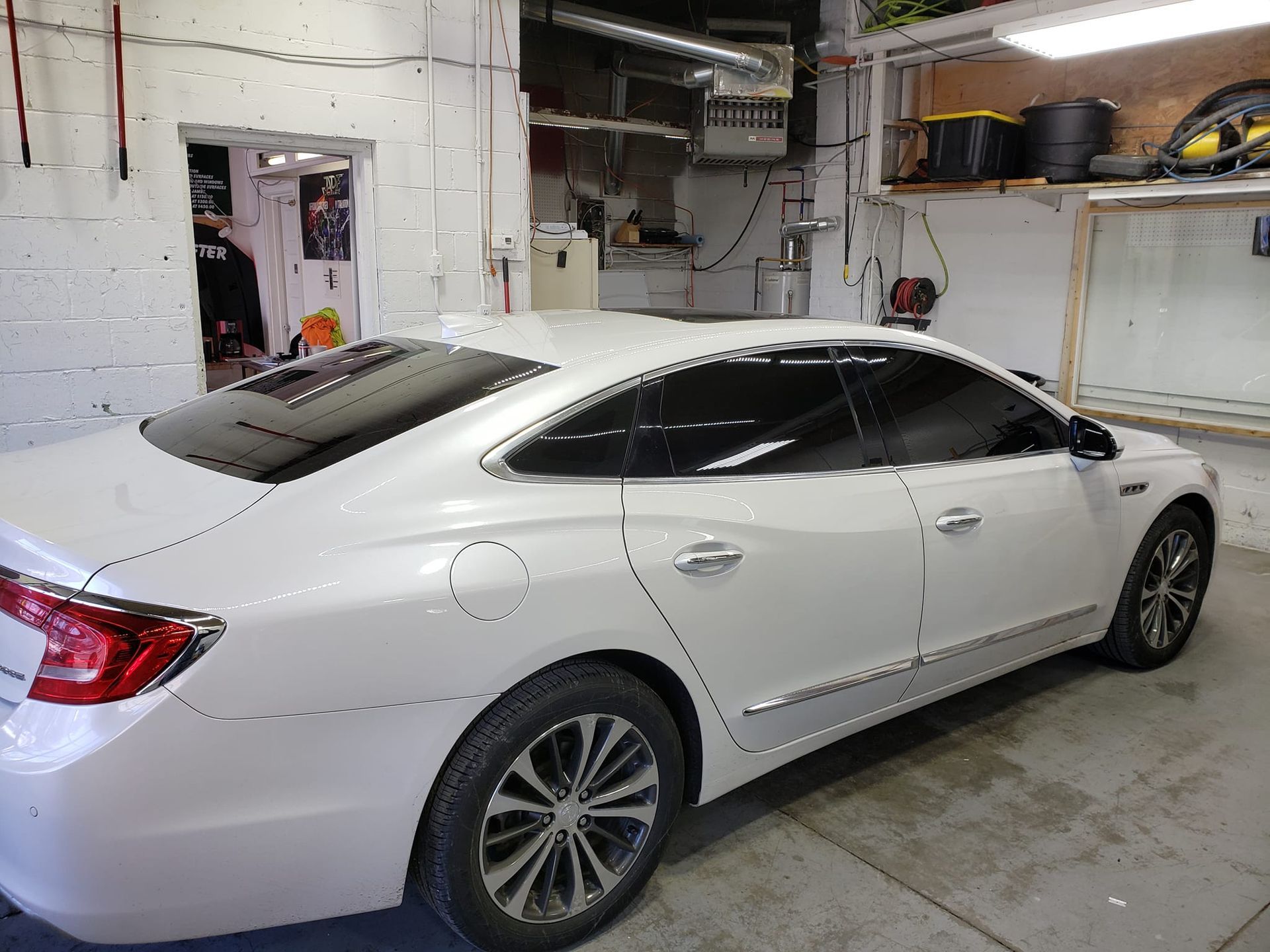A white car is parked in a garage.