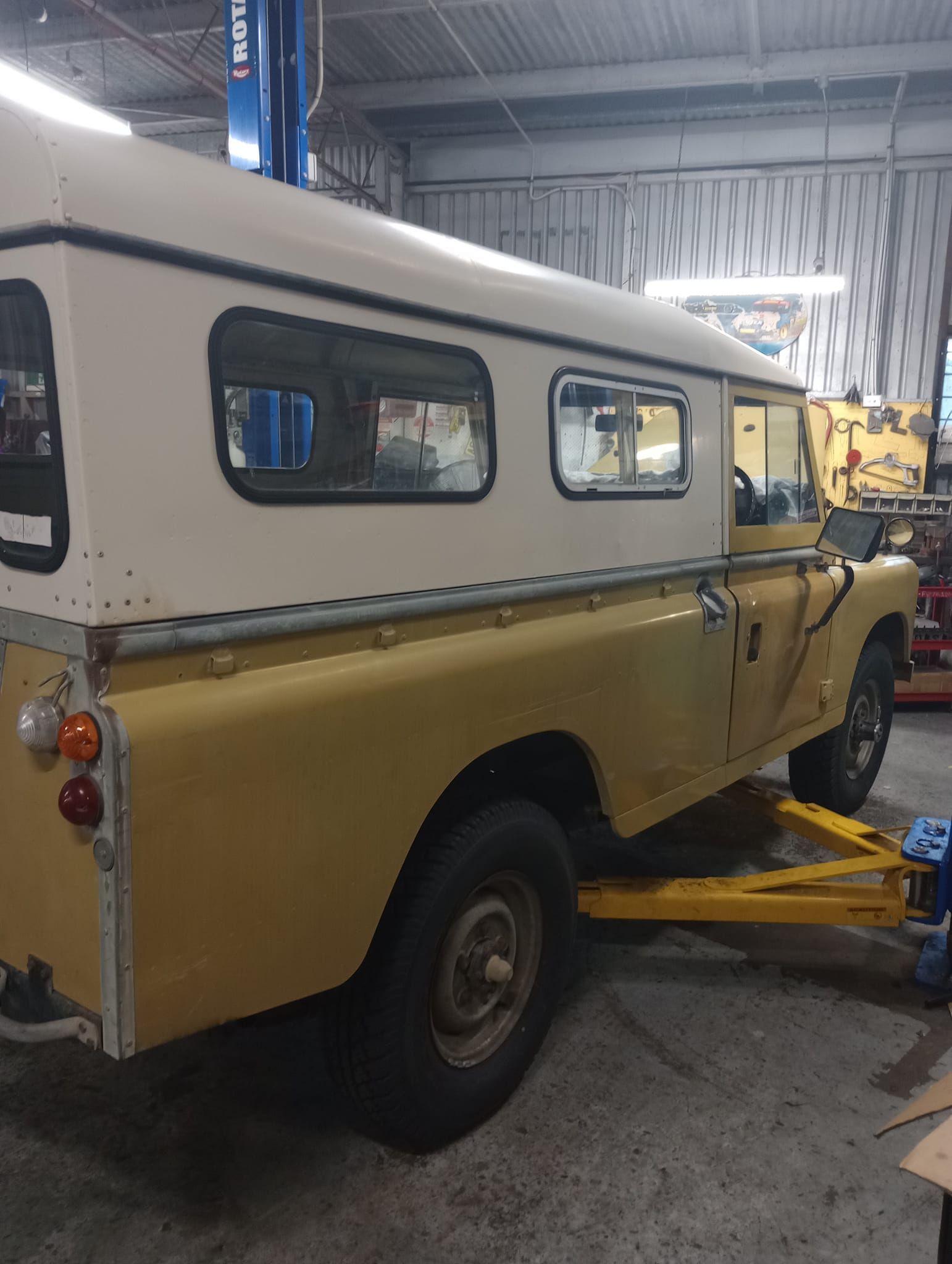 Yellow and White Vintage Land Rover on a Lift — Coopers Auto Care in South Lismore, NSW