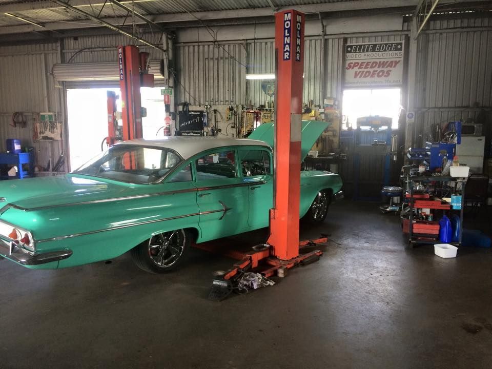 a Teal Classic Car is on a Lift in an Auto Repair Shop — Coopers Auto Care in South Lismore, NSW