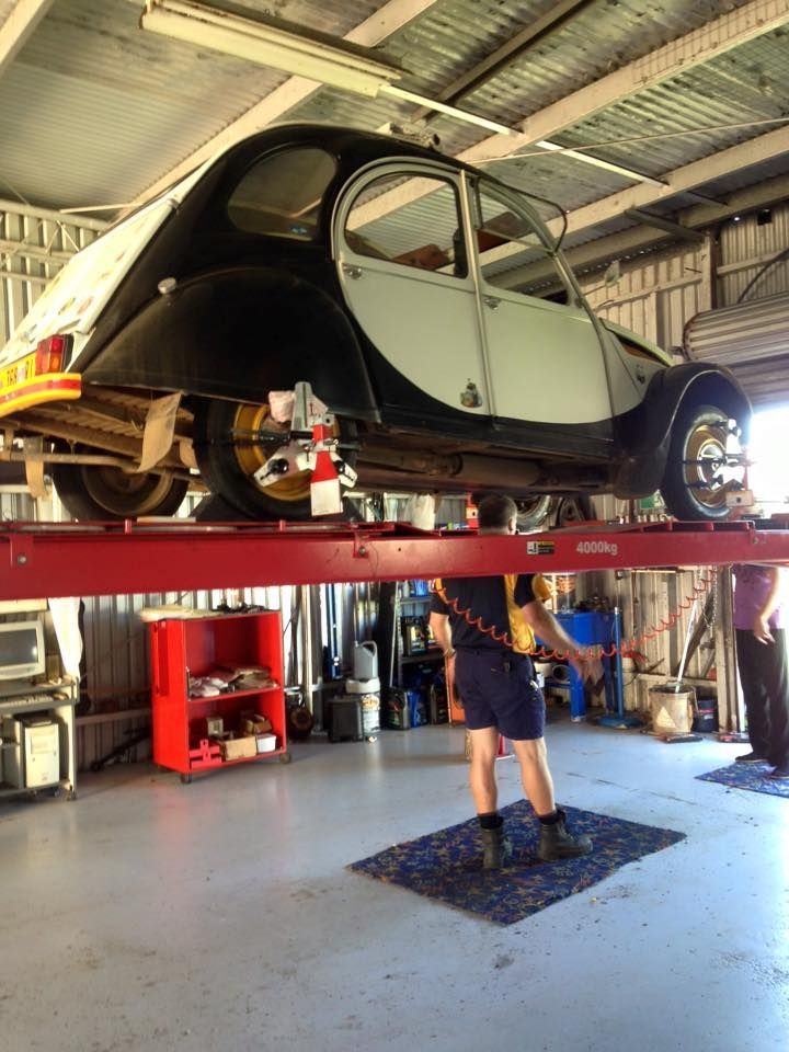 a Classic Two-tone Car on a Red Lift — Coopers Auto Care in South Lismore, NSW