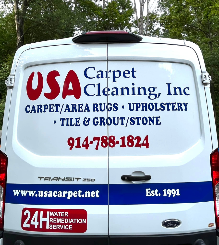 The back of a usa carpet cleaning inc van