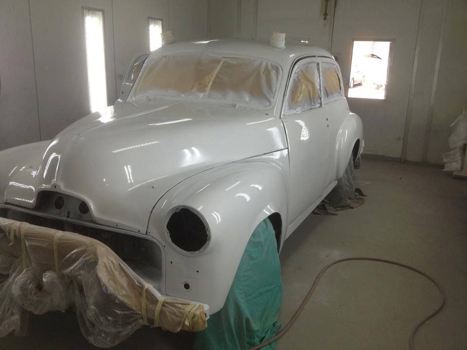 A White Car Is Being Painted In A Garage — All Port Smash Repairs in Port Macquarie, NSW