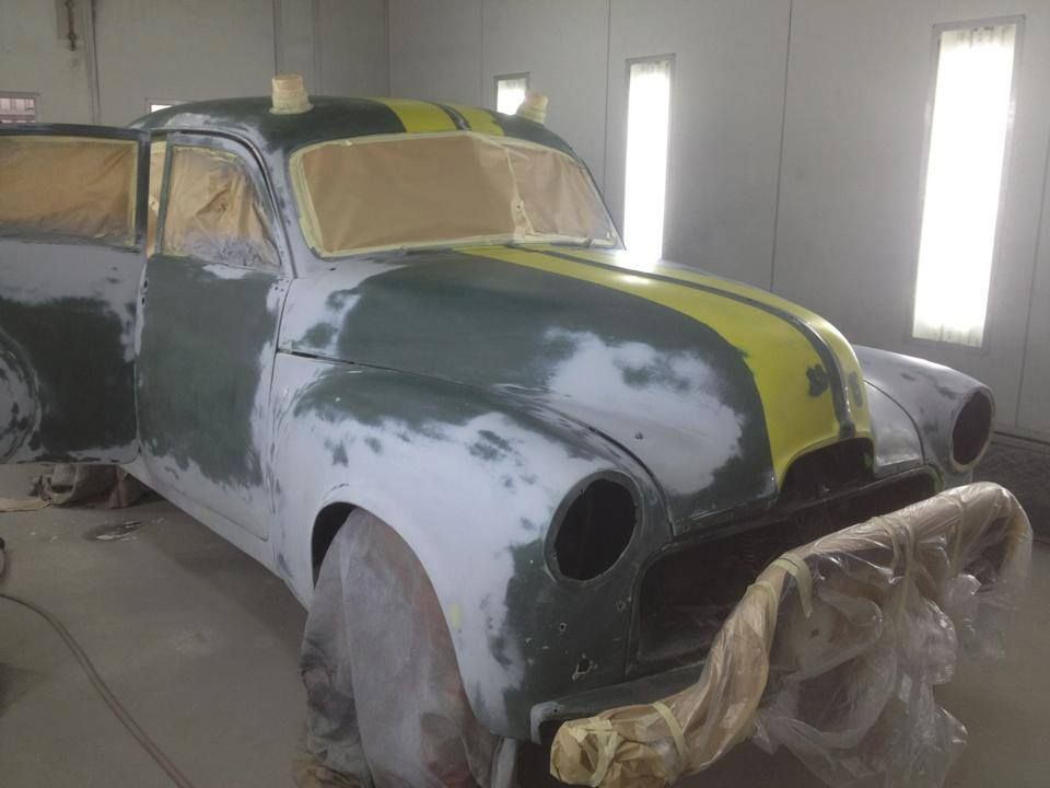 An Old Car Is Being Painted In A Paint Booth — All Port Smash Repairs in Port Macquarie, NSW