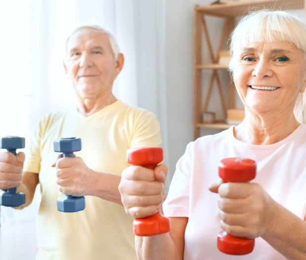 two senior citizens exercising and smiling
