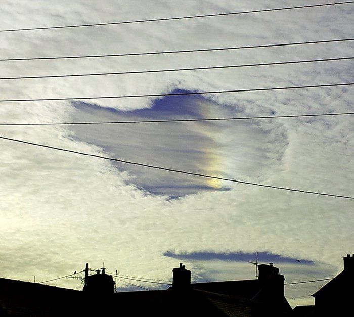 Rainbow within a hole in the Clouds