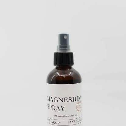 Brown glass bottle of magnesium spray, white label, black cap with sprayer. Level Up Falcon