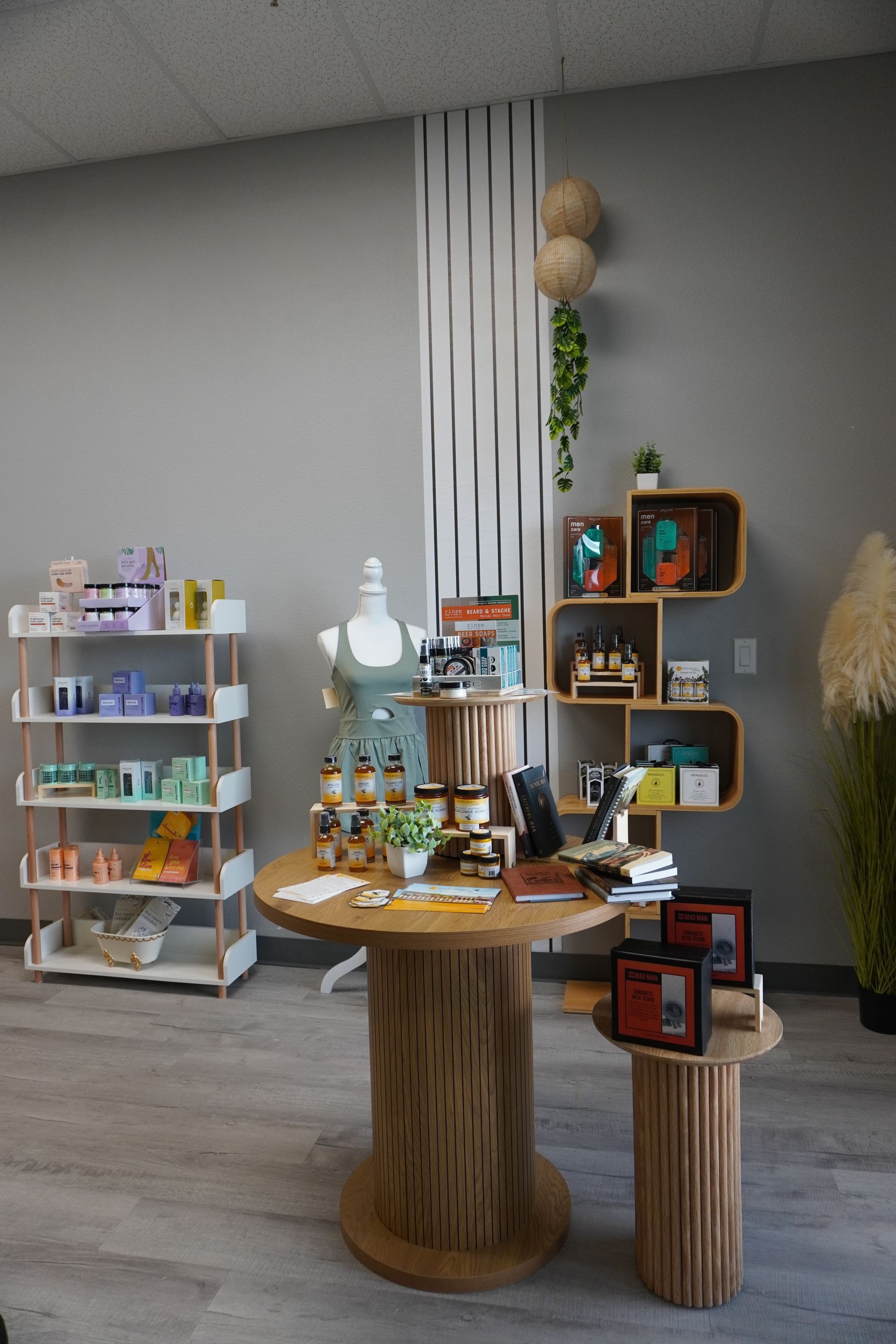 A boutique shop interior with display shelves, a round table, and various products on display. Level Up Falcon