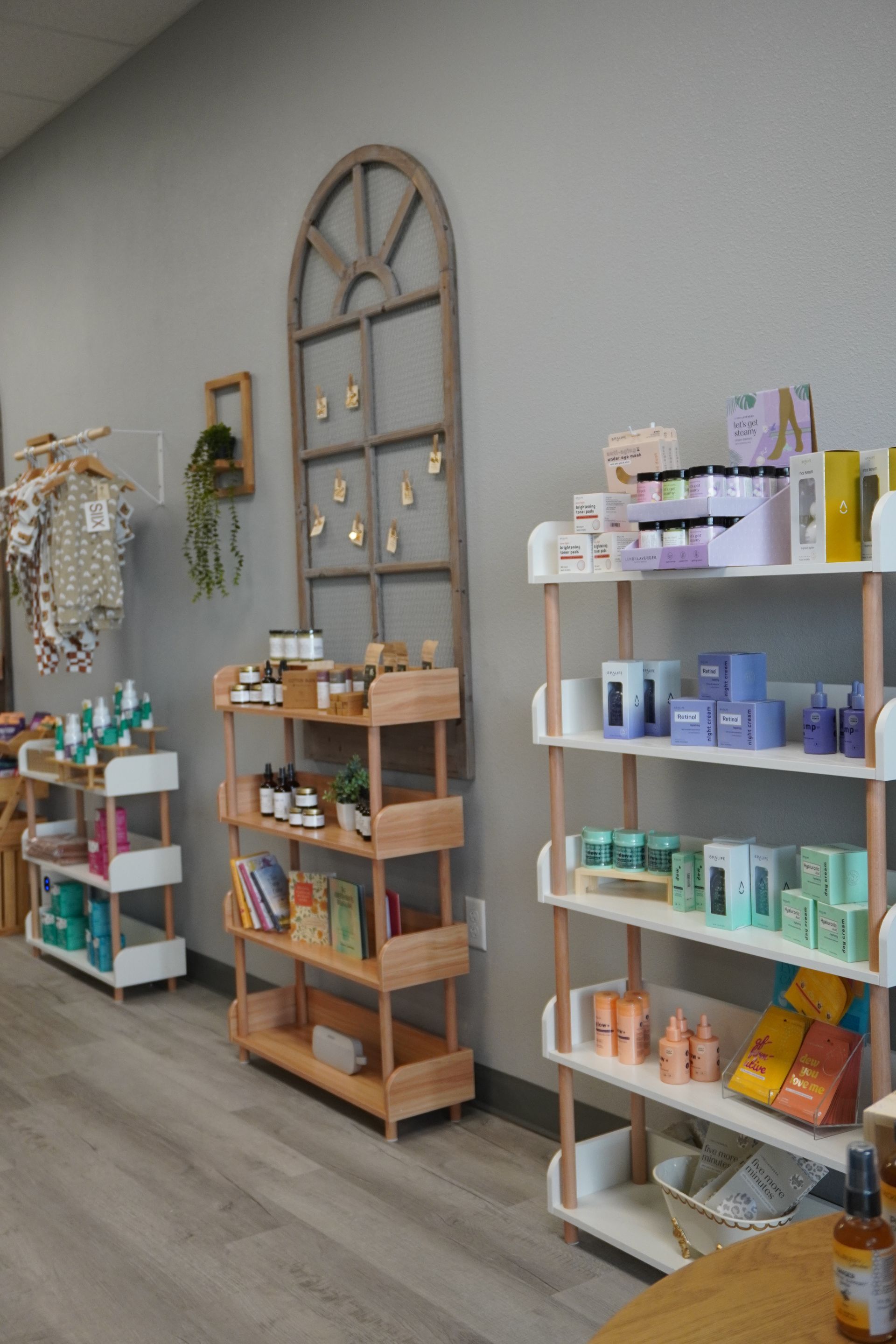 Shelves of products in a retail store, various colors, wooden and white shelving. Level Up Falcon