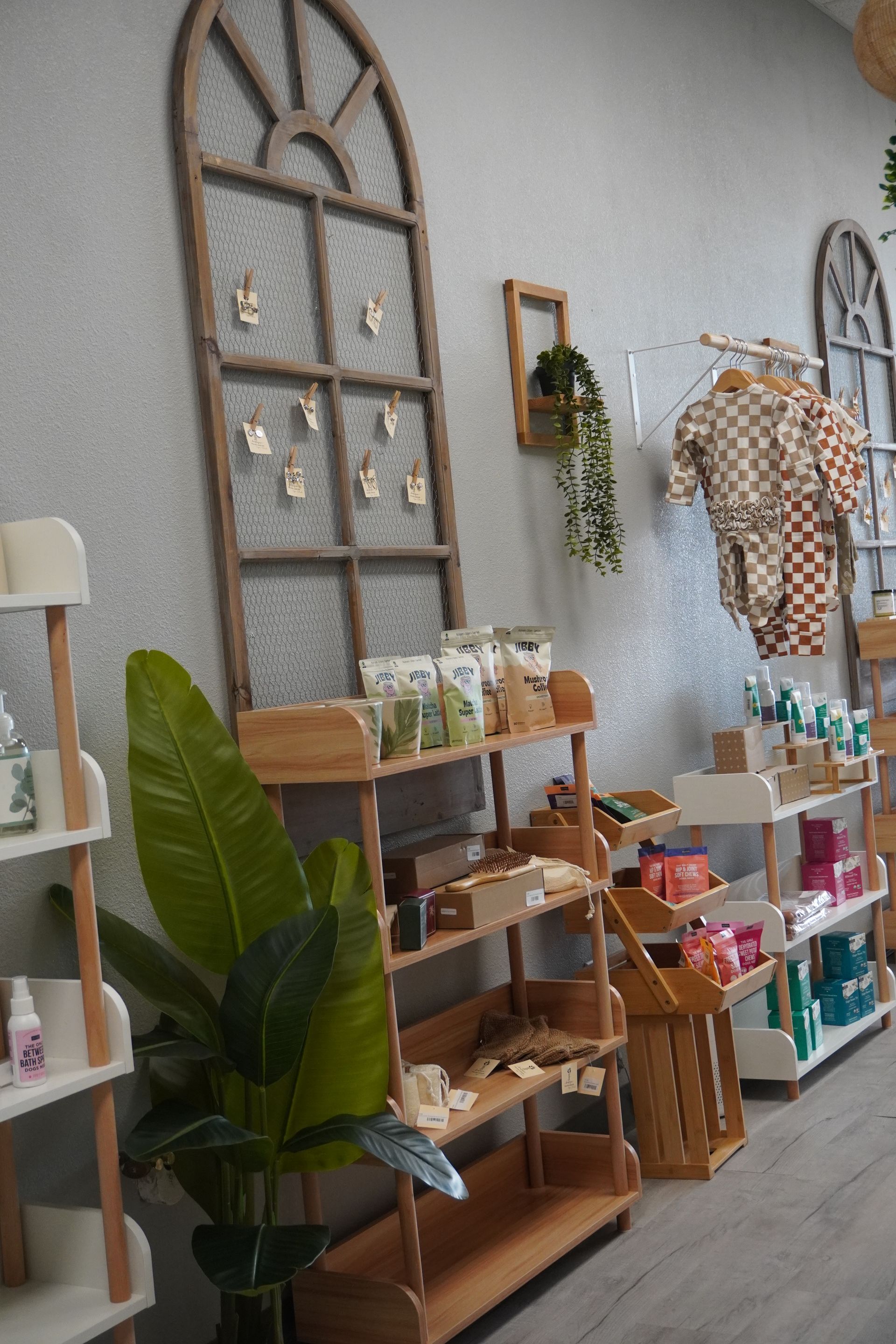 Wooden shelves displaying various products in a store with an arched window-shaped decoration. Level Up Falcon