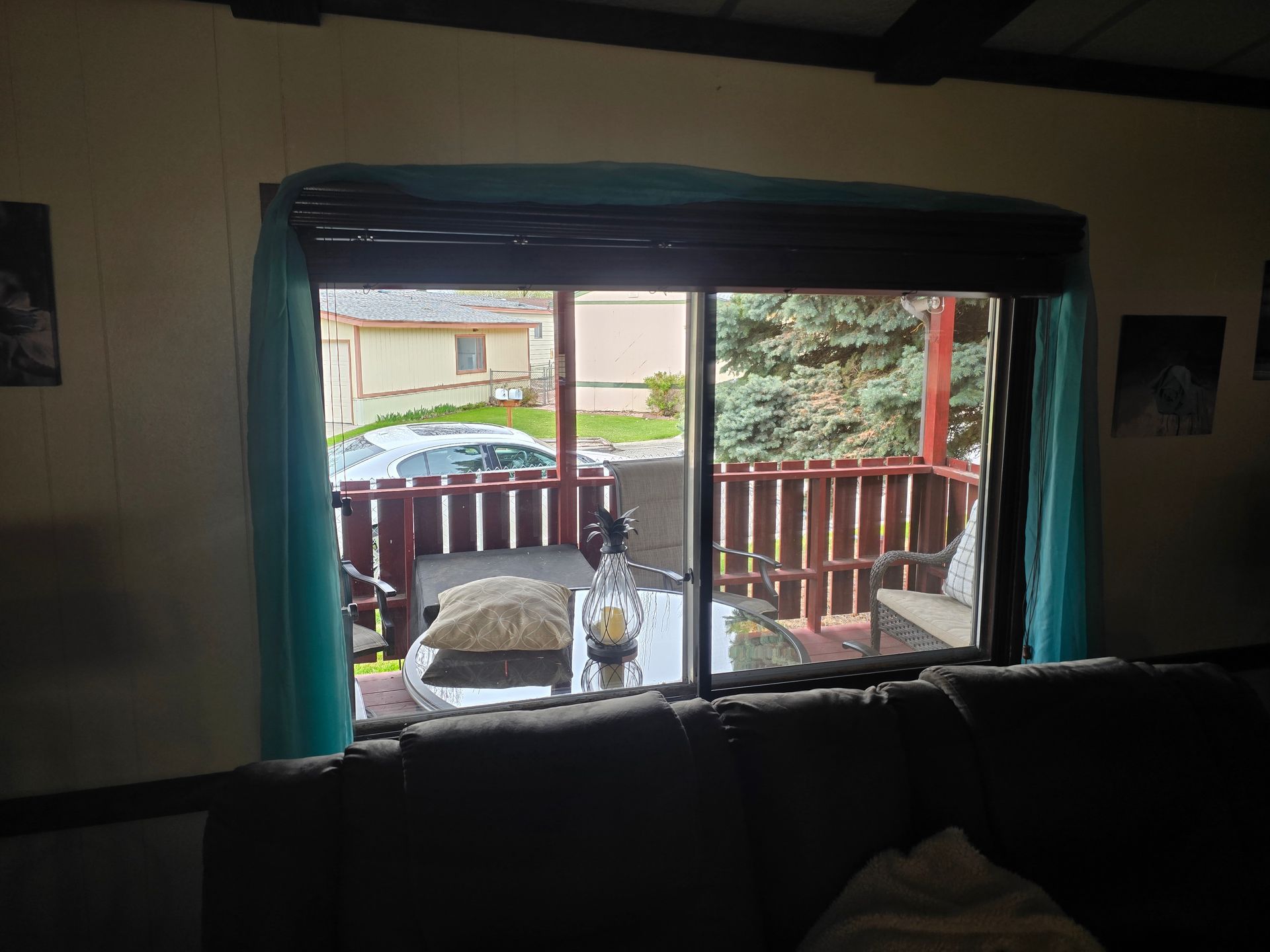 A living room with a sliding glass door leading to a balcony.