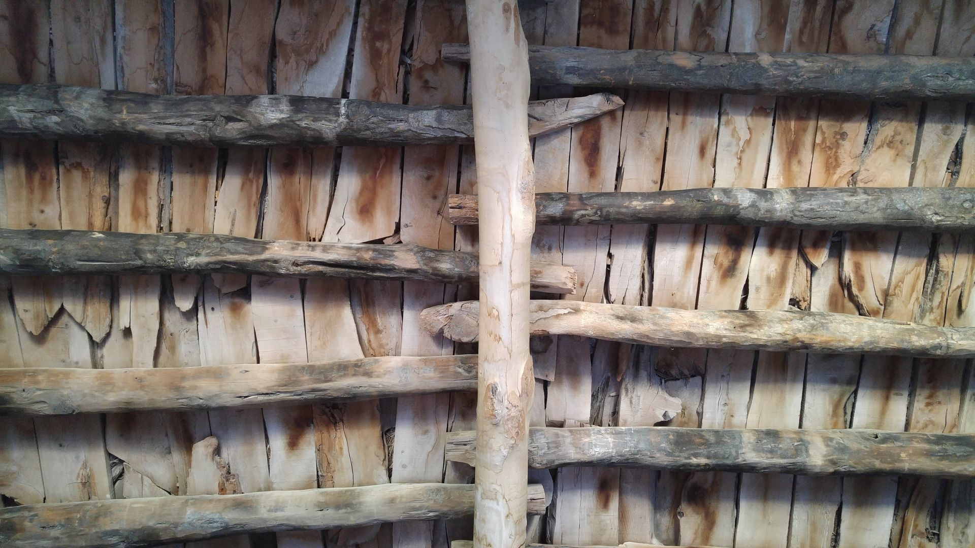 A close up of a wall made of wooden sticks