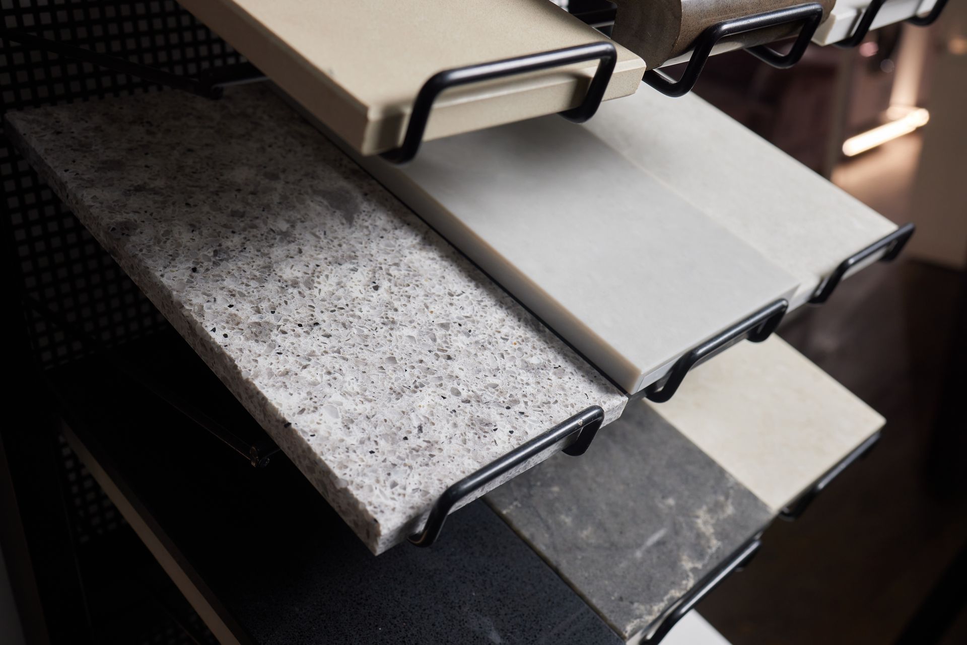 A display of different types of granite counter tops in a store.