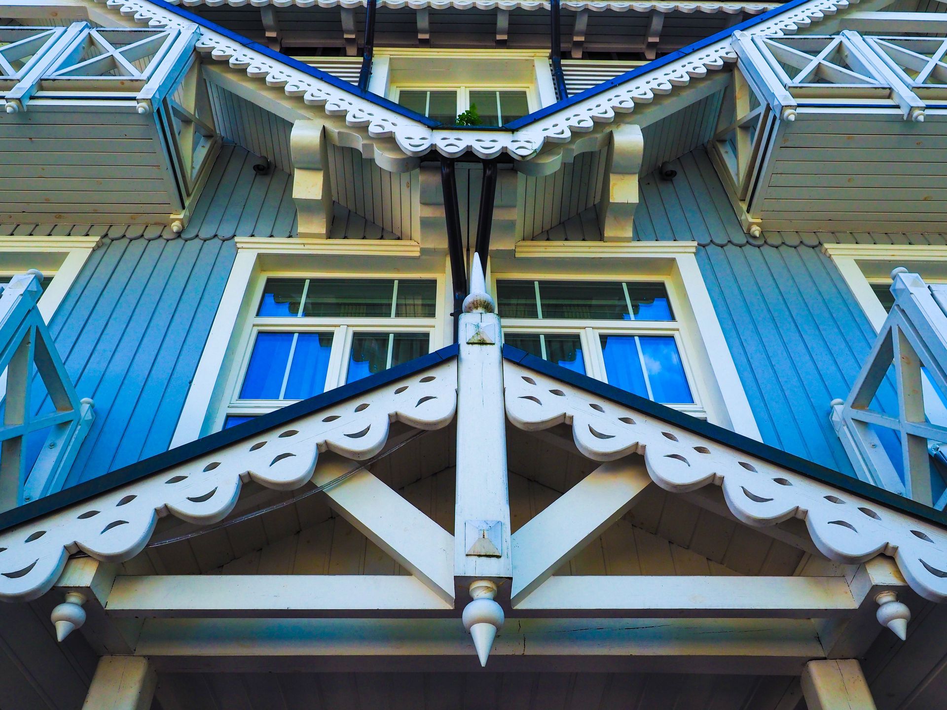 The front of a blue and white house with a white trim