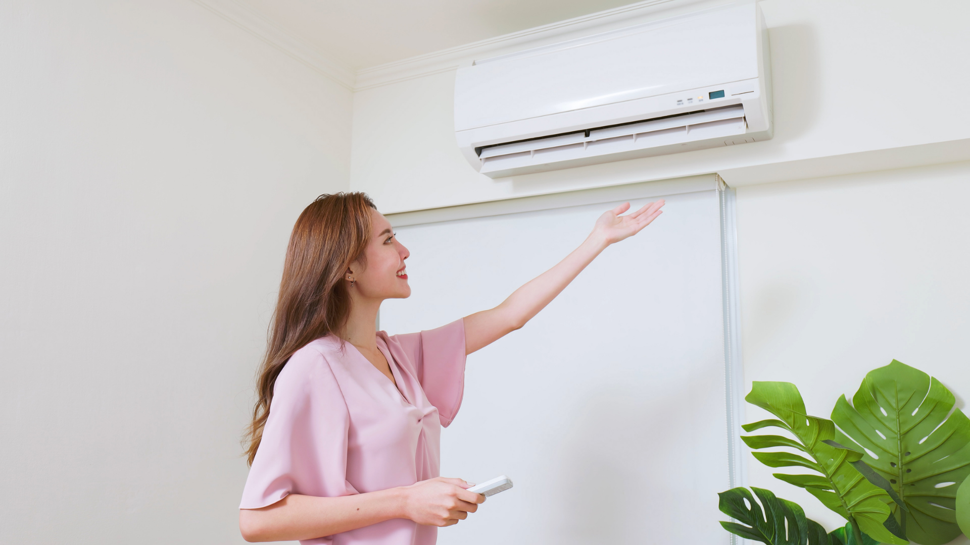 Woman operating a ductless mini split system