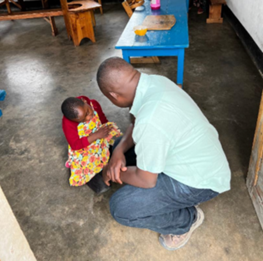 Fr. Nestor greeting an Inuka patient with Cyrabal Palsy