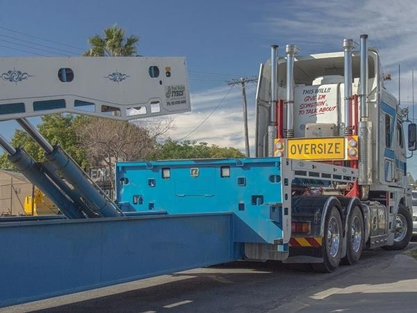 An Oversize Truck Is Driving Down The Road — RJN Transport In Tamworth, NSW