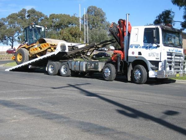 A Tow Truck With A Tractor On The Back Of It — RJN Transport In Moree, NSW