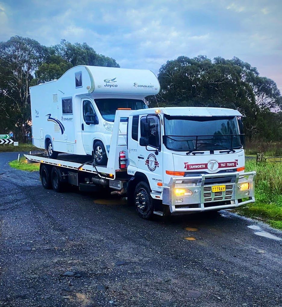 A Tow Truck With A Tractor On The Back Of It — RJN Transport In Tamworth, NSW